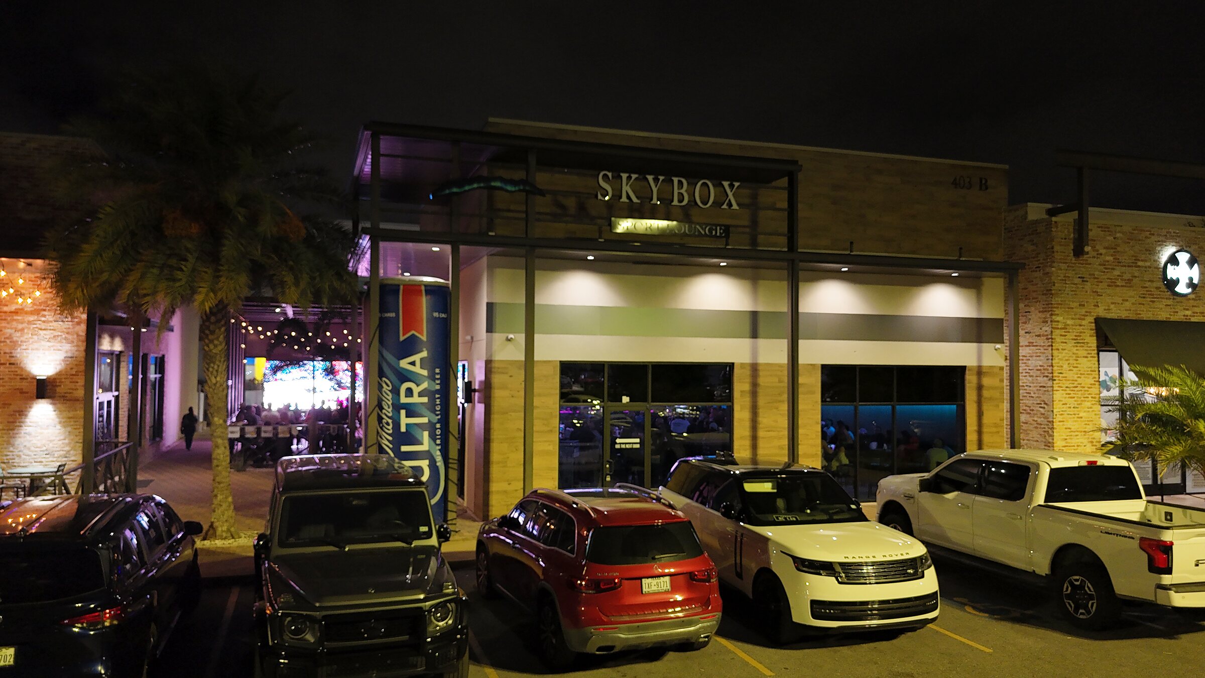 SKYBOX Sports Lounge lit up on game night in Edinburg, TX