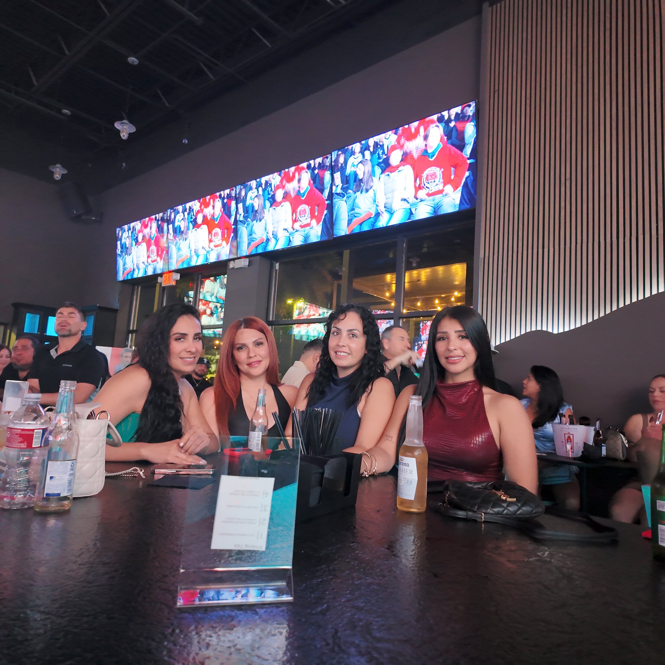 Inside the SKYBOX lounge — the 30-foot LED wall glowing over the bar
